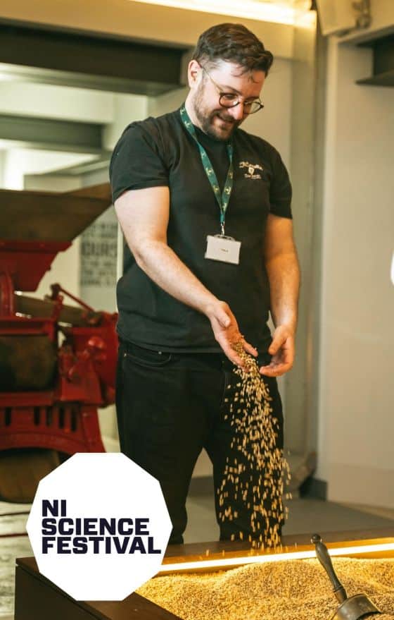 Picture of a tour guide pouring grain